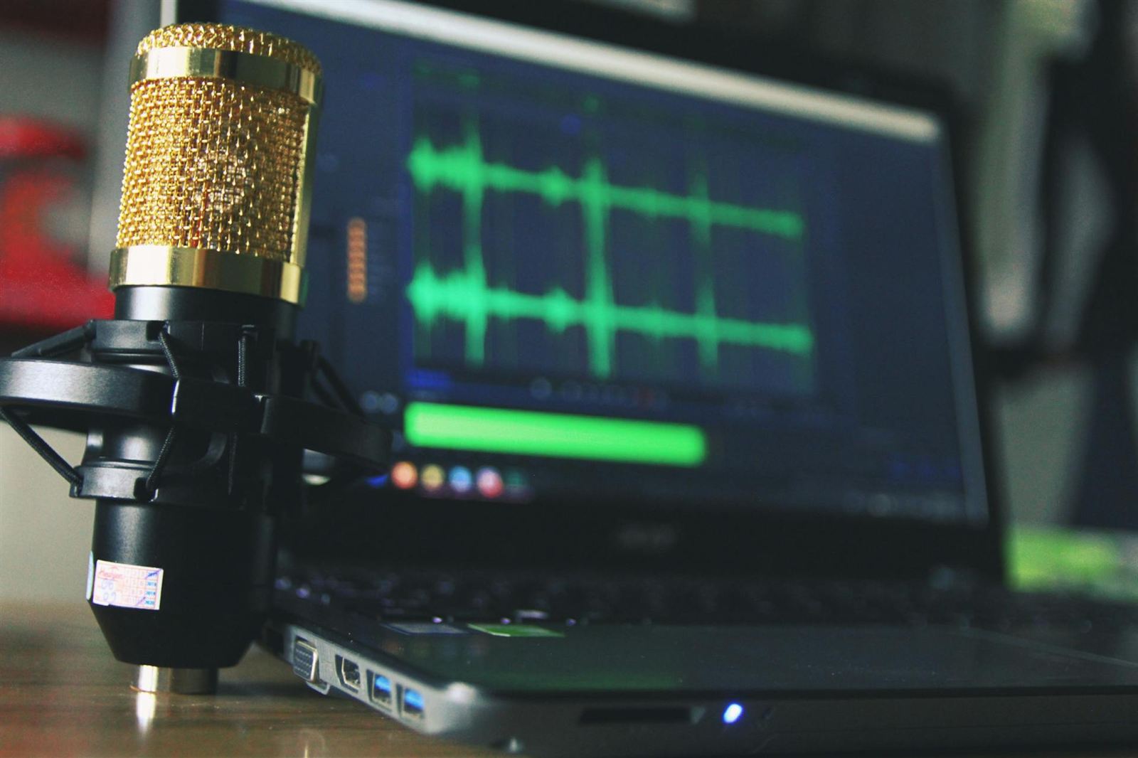 Unabhängiger Musiker arbeitet am Laptop mit Kopfhörern und verfolgt seine Musik-Tantiemen und Streaming-Einnahmen